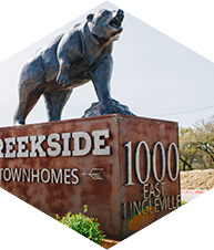 a larger hexagonal image of the bear statue at creekside townhomes